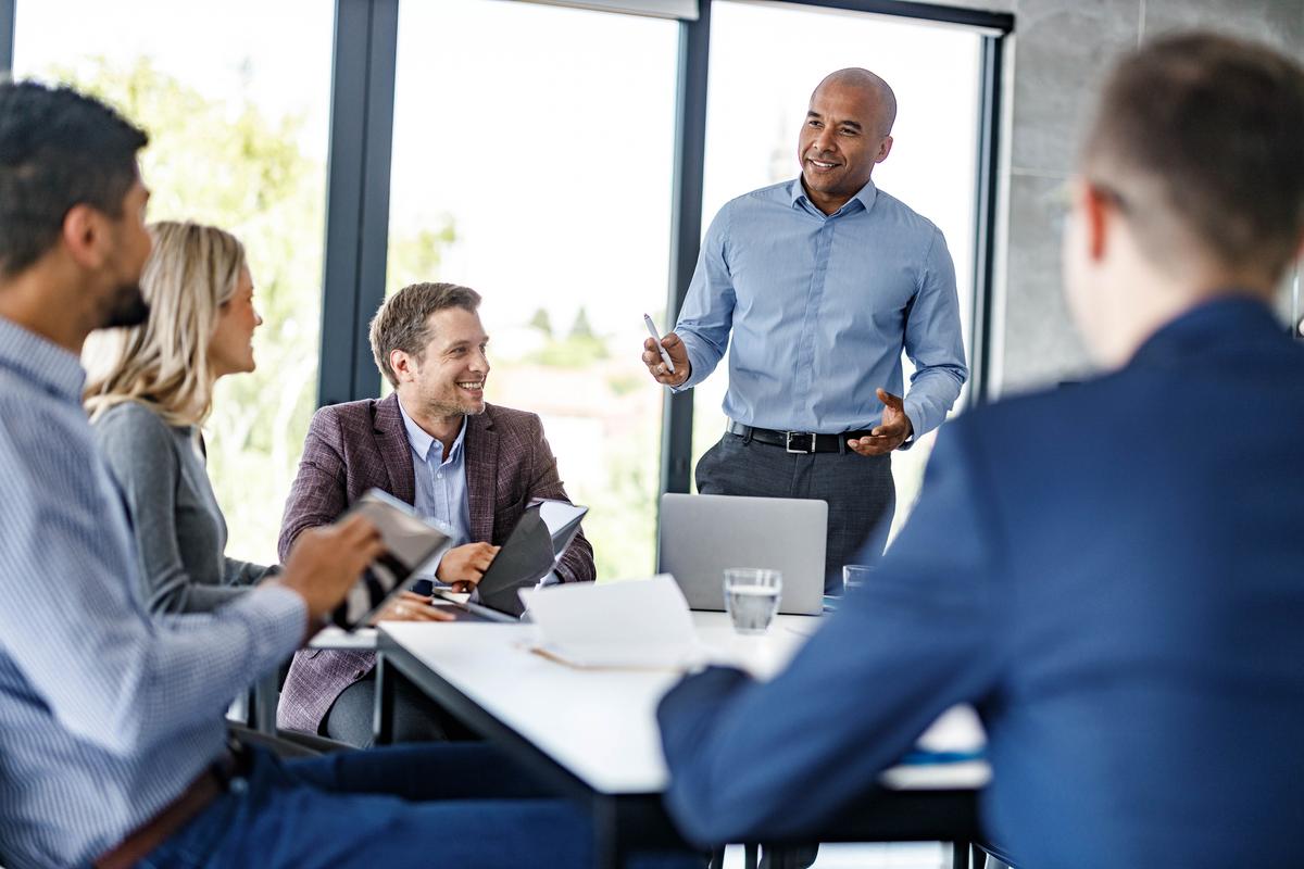 African American CEO talking to his team on a meeting in the office.
