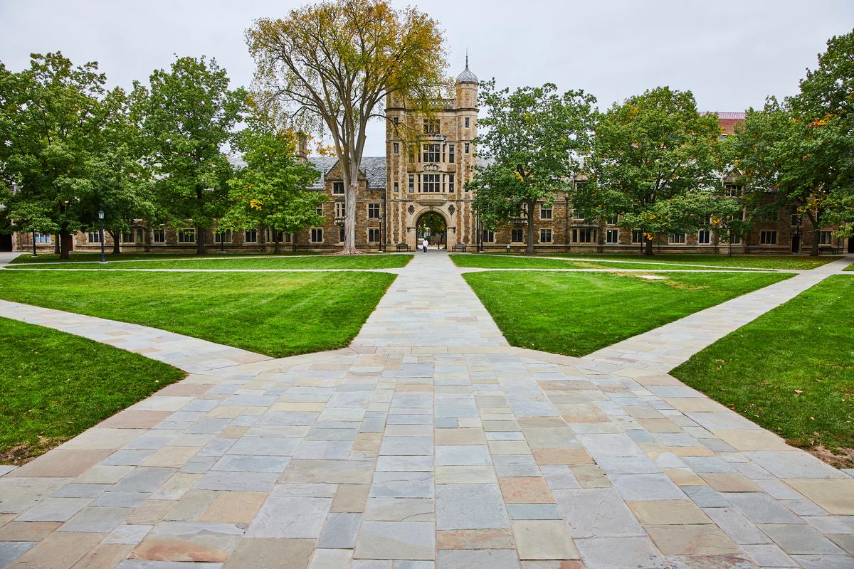 Historic University Building with Autumnal Trees and Pathways