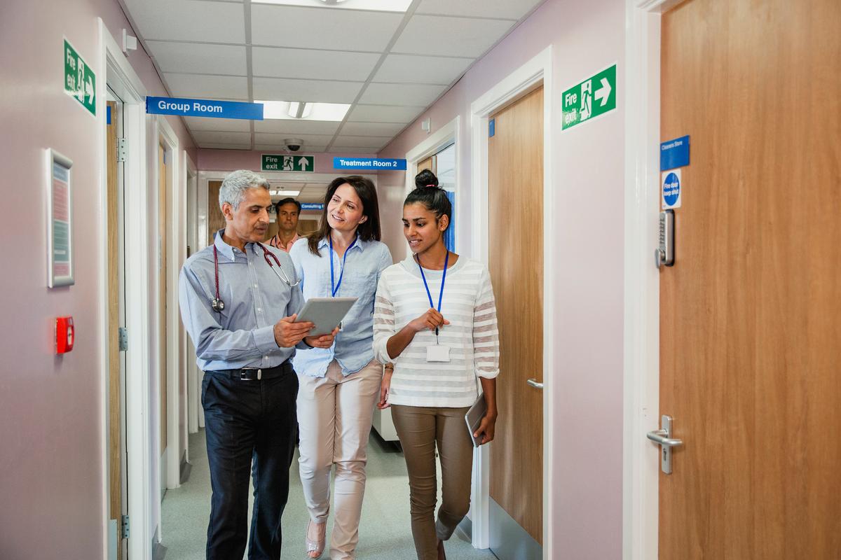 Three Doctors Walking Down the Corridor