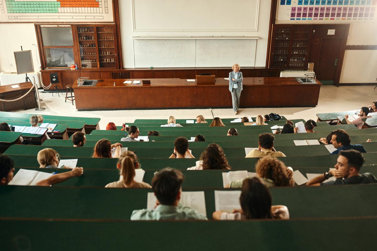Group of students at a college class in a stadium seating layout.