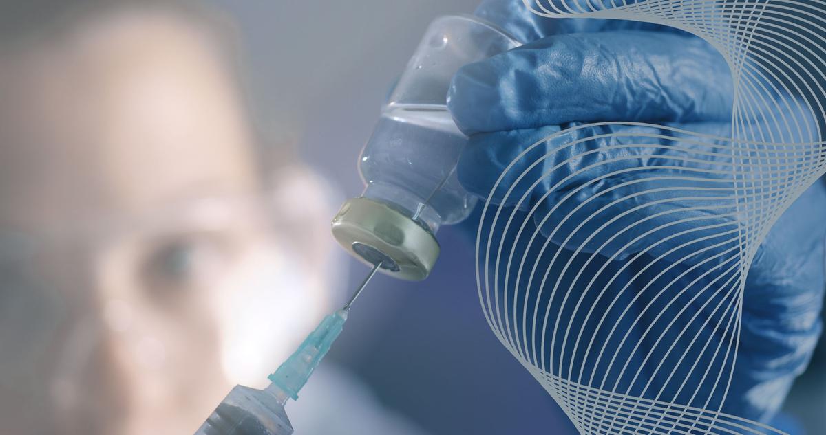 Medical professional draws vaccine from vial.
